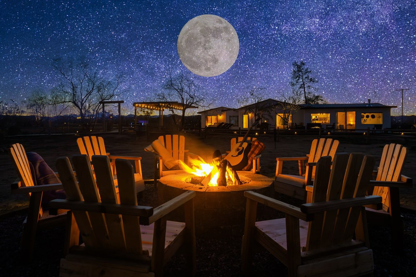 Adirondack chairs around the fire pit under a full moon