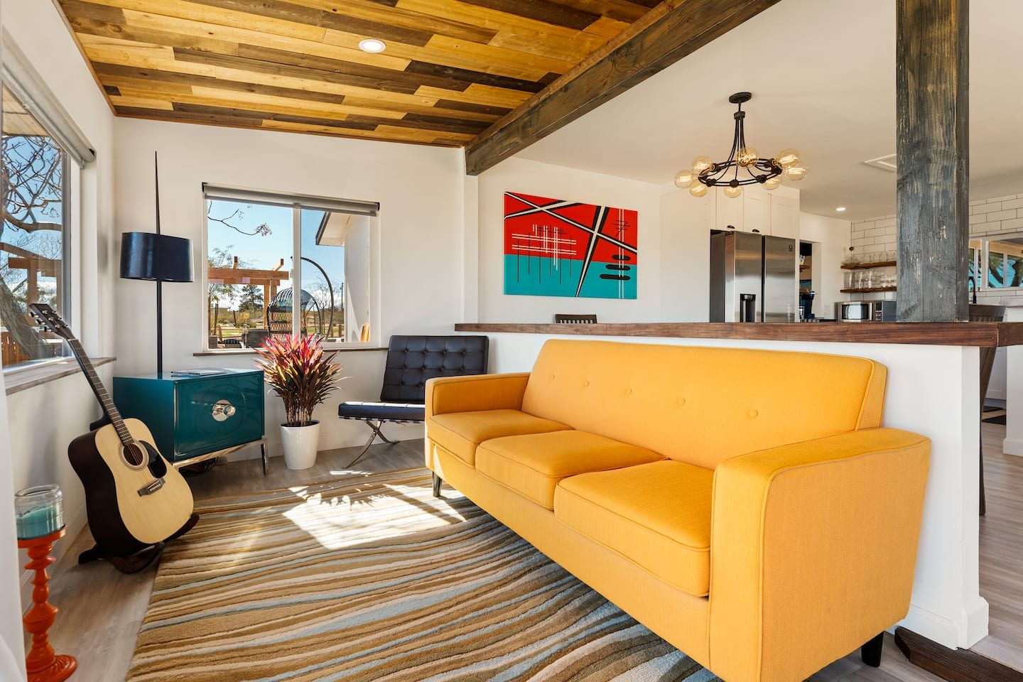 Living room with yellow sofa and guitar