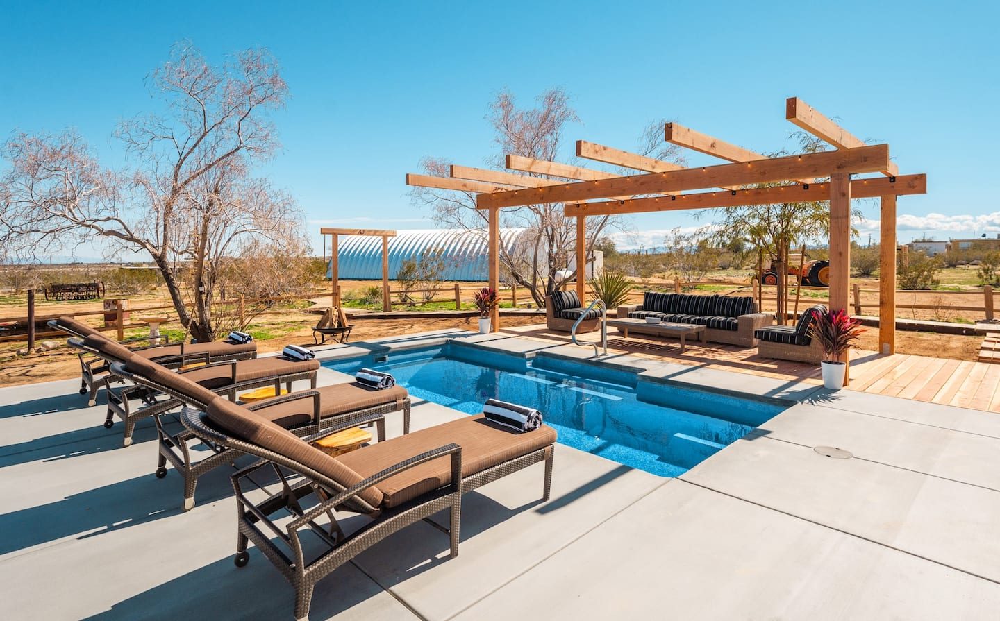 Pool with shaded pergola and loungers