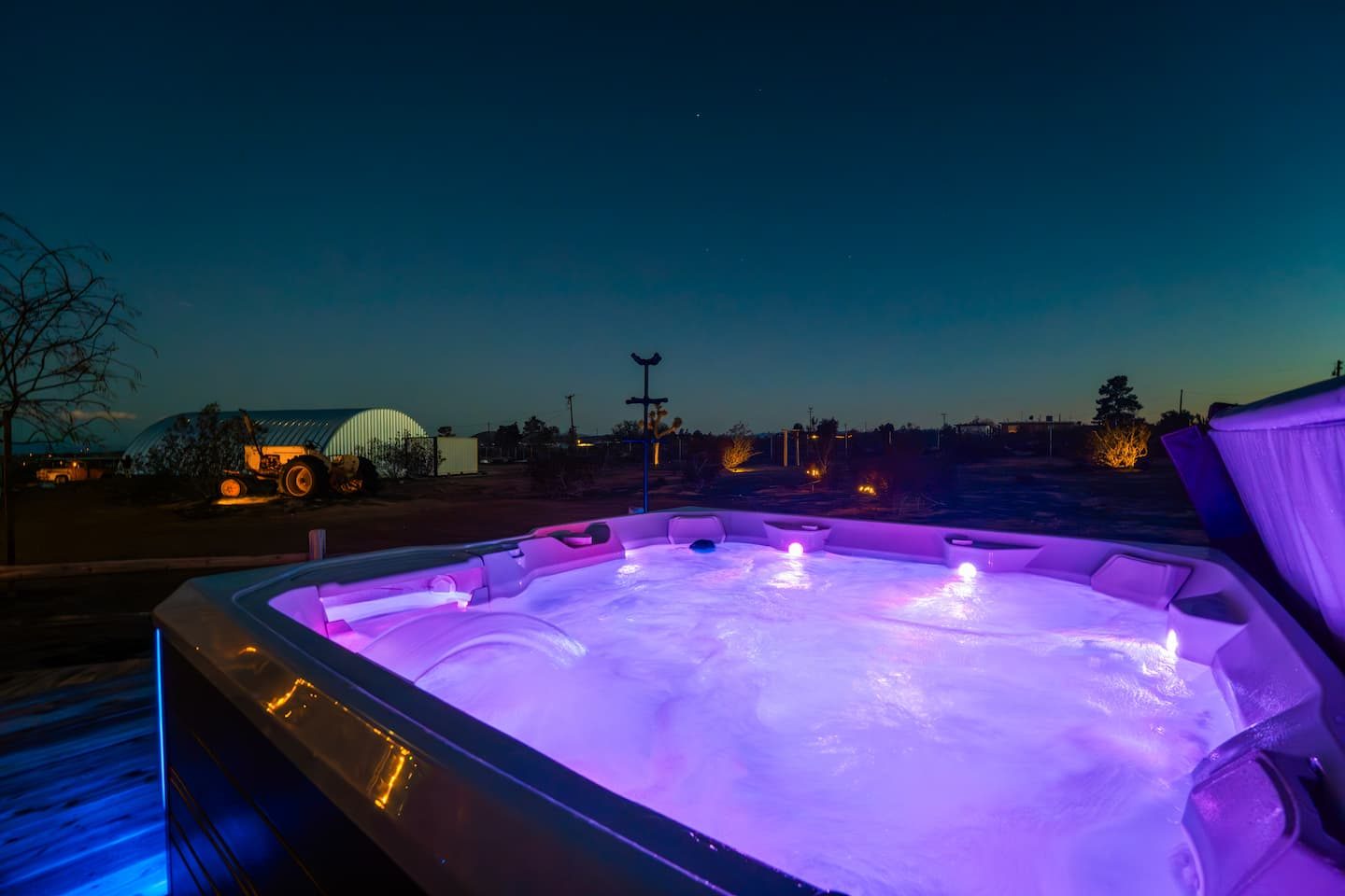 Hot tub glowing under the night sky